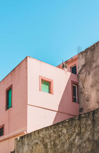 Low angle view of building against clear blue sky