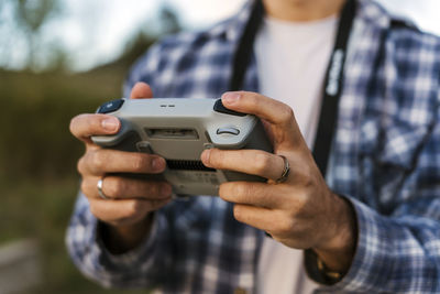 Man operating drone through remote control