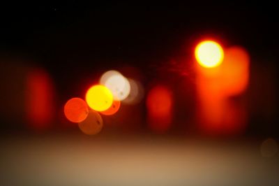 Defocused image of illuminated street at night