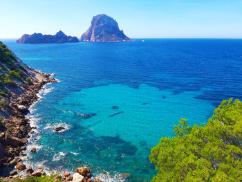 Naturalistic maritime panorama of es vedra in the sea of ibiza from cala d'hort in balearic islands