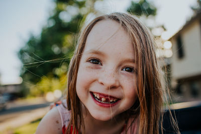 Happy young girl smiling and showing missing tooth