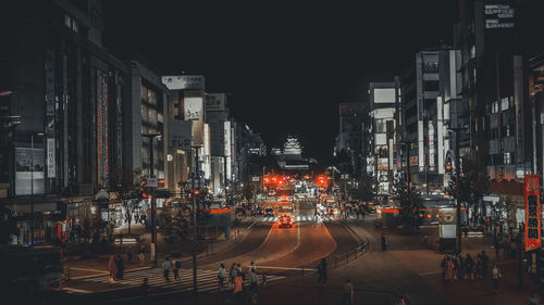 Illuminated city street and buildings at night