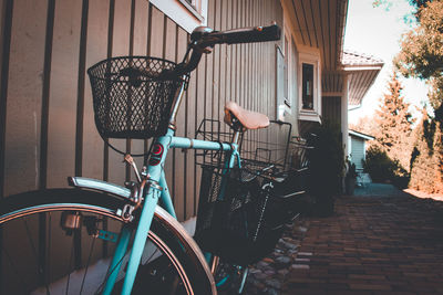 Bicycle parked on footpath by building