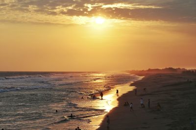 Scenic view of beach against sky during sunset