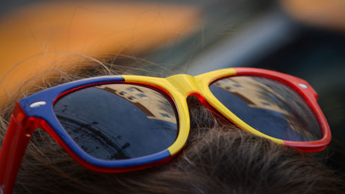 Cropped image of person wearing sunglasses on head