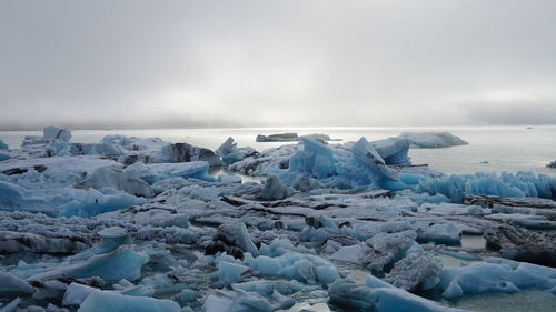 Scenic view of icebergs against sky