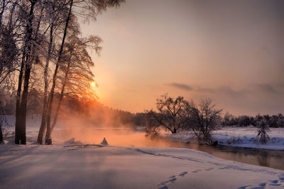 Scenic view of landscape against sky during winter