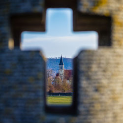 Close-up of cross against wall in old building