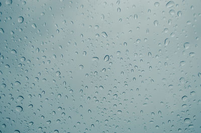 Full frame shot of raindrops on glass window