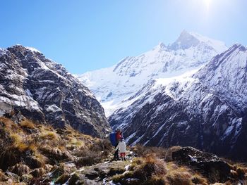 Scenic view of snowcapped mountains against sky during sunny day