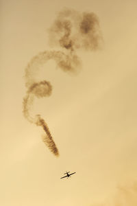 Low angle view of airplane flying in sky