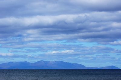 Scenic view of sea and mountains against sky