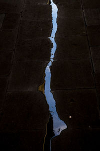 Reflection of clouds in puddle