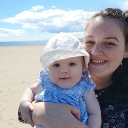 Portrait of happy mother and son on land