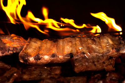 Close-up of burning candles on barbecue