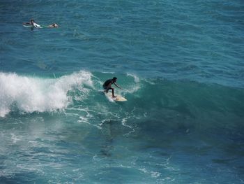 Man surfing on waves in sea