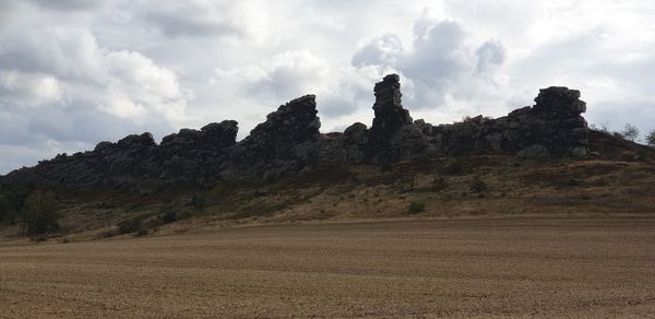 Rock formations on landscape against sky