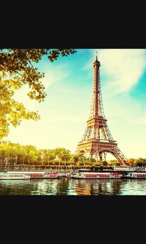 architecture, built structure, eiffel tower, sky, famous place, travel destinations, transfer print, international landmark, water, metal, capital cities, tower, tourism, bridge - man made structure, culture, travel, low angle view, river, tree, auto post production filter