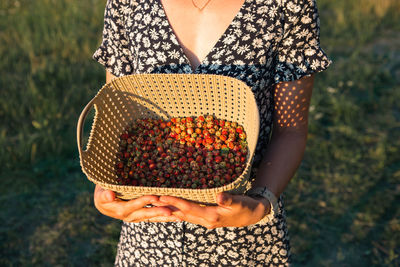 Midsection of woman holding purse