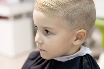 Close-up portrait of cute boy looking away