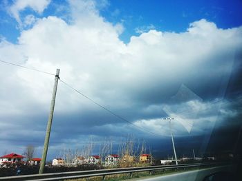 Low angle view of train against cloudy sky