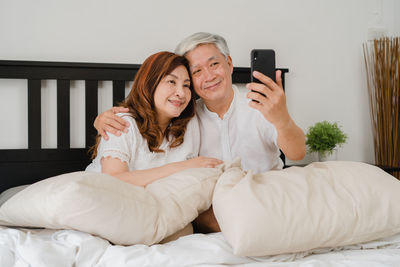 Portrait of smiling young woman using mobile phone