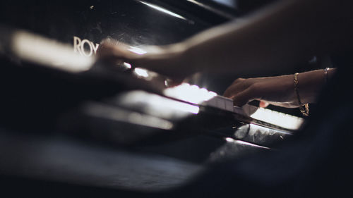 Cropped image of woman playing piano