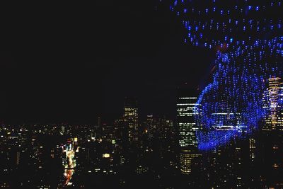 Illuminated buildings in city at night