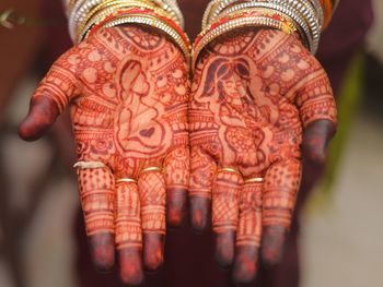 Midsection of woman with henna tattoo