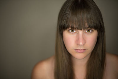 Close-up portrait of beautiful young woman over white background