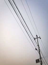 Low angle view of electricity pylon against sky