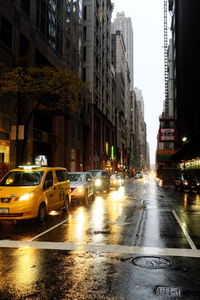 Cars on city street during rainy season