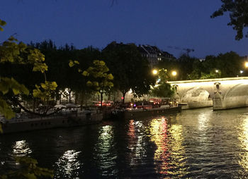 View of bridge over river at night