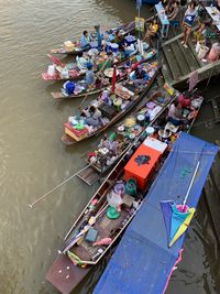 High angle view of people in boats on river at floating market