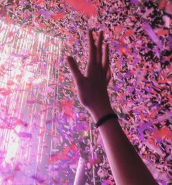 Close-up of hands against multi colored background