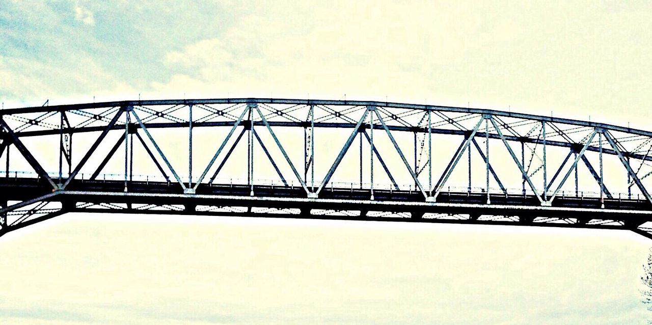 connection, bridge - man made structure, built structure, low angle view, architecture, engineering, bridge, sky, copy space, clear sky, transportation, railing, no people, metal, outdoors, suspension bridge, day, long, river, nature