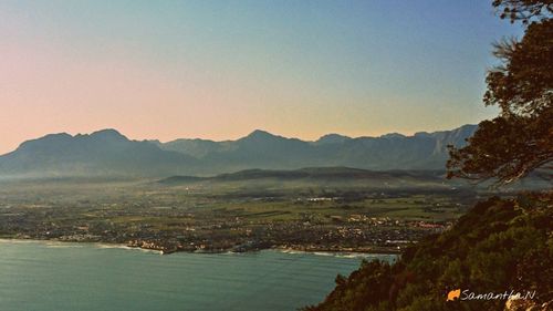 Scenic view of sea and mountains against sky