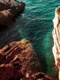 High angle view of rock formations by sea