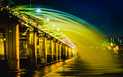 Illuminated lights in city against sky at night