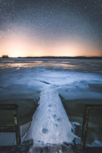 Scenic view of frozen sea against sky at night