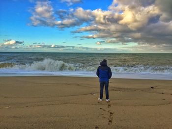 Rear view of man standing on beach