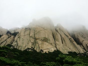 Scenic view of mountain against cloudy sky