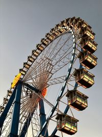 Low angle view of ferris wheel against sky