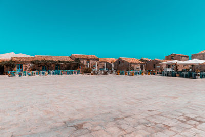 View of buildings in city against clear blue sky