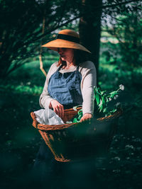 Woman wearing hat while standing in basket