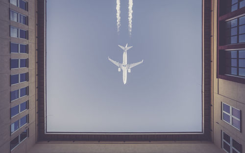 Directly below shot of airplane flying in sky