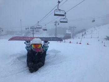 Ski lift over snow covered mountain