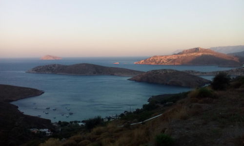 Scenic view of sea and mountains against sky