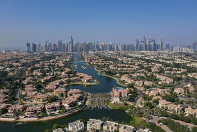 Drone shot of jumeirah islandisla and dubai marina in a far background. united arab emirates.