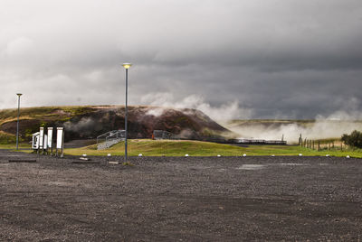 Scenic view of soccer field against cloudy sky